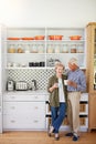 May your coffee be as strong as your love. a happy senior couple bonding over coffee in their kitchen at home. Royalty Free Stock Photo
