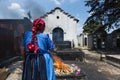 Maya woman performing a traditional mayan ritual in the cemetery of the town of Chichicastenango, in Guatemala