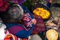 A Mayan woman is offering her flower petals in the market. Royalty Free Stock Photo