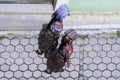 Two Mayan women are walking down a street in Zunil Guatemala.