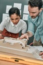 Maybe we should section off this space. two architects working together on a scale model of a building in an office. Royalty Free Stock Photo