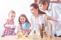 Scared group of elementary students and tutor during scientific experiment Royalty Free Stock Photo