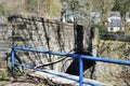 Mayen, Germany - 03 30 2021: stone bridge across the Nette with rusty blue metal