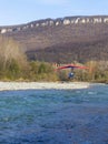 Walking on a motor hang glider along the bed of a mountain river on an autumn sunny day, an unforgettable experience.++