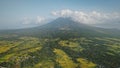 Mayon volcano erupts at Philippines countryside aerial. Tropic green forest plants and grasses
