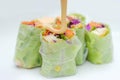 mayonnaise on a salad roll made from vegetable ingredients such as carrots, cabbage, purple cabbage, cucumber, roasted chicken