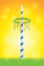 maypole with colorful ribbons on sunny sky background