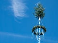 Maypole in spring on blue background