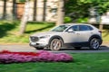 Mazda CX-30 crossover driving quickly with motion blur effect