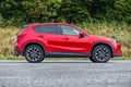 Mazda CX-5 metallic red paint in a parking lot