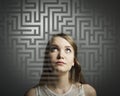 Maze. Girl in white solving a problem.