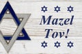 Mazel Tov message with star of David on weathered white wood