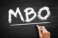 MBO Management By Objectives - strategic approach to enhance the performance of an organization, acronym text on blackboard Royalty Free Stock Photo