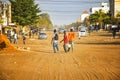 Mbour, SENEGAL - APR 26, 2019: Unidentified Senegalese men are walking down a dusty road in the middle of the city