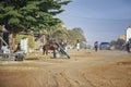 Mbour, SENEGAL - APR 26, 2019: Unidentified Senegalese woman with baby are walking down a dusty road in the middle of the city.