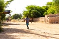 Poor african senegalese child walking street looking for food. Talibe koran school