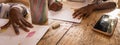 Unidentified young child writing letter to godfather or godmother. Close-up on hands