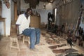 Mbour, Senegal, handcrafts seller posing inside his small shop