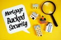 MBS Mortgage-backed Security text with house models and magnifying glass on yellow background Royalty Free Stock Photo
