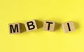 MBTI acronym, inscription on wooden dices. Types of personalities concept