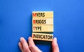 MBTI Myers Briggs type indicator symbol. Concept words MBTI Myers Briggs type indicator on block on beautiful blue background.