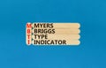 MBTI Myers Briggs type indicator symbol. Concept words MBTI Myers Briggs type indicator on wooden stick on beautiful blue