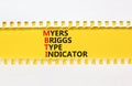 MBTI Myers Briggs type indicator symbol. Concept words MBTI Myers Briggs type indicator on yellow paper on beautiful white