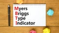 MBTI Myers Briggs type indicator symbol. Concept words MBTI Myers Briggs type indicator on white note on beautiful wooden Royalty Free Stock Photo