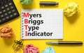 MBTI Myers Briggs type indicator symbol. Concept words MBTI Myers Briggs type indicator on white note on beautiful yellow