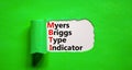 MBTI Myers Briggs type indicator symbol. Concept words MBTI Myers Briggs type indicator on white paper on beautiful green