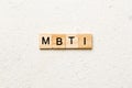 MBTI word written on wood block. Myers-Briggs Type Indicator text on table, concept