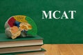 MCAT message with model brain with anatomy on books Royalty Free Stock Photo