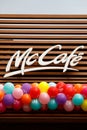 McCafe and McDonald's logo on the new restaurant opening. Birthday concept. Balloons under the sign.