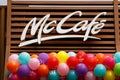 McCafe and McDonald's logo on the new restaurant opening. Birthday concept. Balloons under the sign.