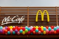 McCafe and McDonald's logo on the new restaurant opening. Birthday concept. Balloons under the sign.