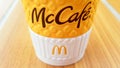 McCafe menu at McDonalds restaurant. Yellow cup of coffee on the table outdoors close-up. Breakfast, coffee time. Ukraine, Kiev -