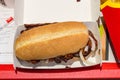 McDonald McRib sandwich in paper box.