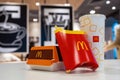 McDonald\'s logo on a French fries box in selective focus. Big Mac hamburger menu on table. Minsk, Belarus, 2023 Royalty Free Stock Photo