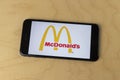 McDonald`s logo on a smartphone. McDonald`s is offering delivery and drive thru service during social distancing