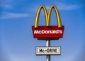 A McDonald`s McDrive sign against the blue sky