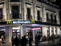 McDonald`s restaurant fast food entrance in historic building of Circular quay branch at night time.