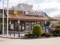 McDonald`s restaurant in an urban area near residential apartments, McDonalds building facade detail frontal shot, empty lot, cit