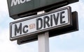 McDonalds company McDrive drive thru outdoors signpost logo sign pole object detail, closeup, nobody. Mc Donalds Mc Drive Royalty Free Stock Photo