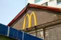 McDonalds logo drawn with yellow paint on an old ugly building Royalty Free Stock Photo