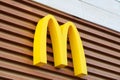 McDonalds logo on fast food restaurant branch, yellow macdonald logo of popular fast food company Royalty Free Stock Photo