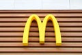 McDonalds logo on fast food restaurant branch, yellow macdonald logo of popular fast food company Royalty Free Stock Photo