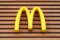 McDonalds logo on fast food restaurant branch, yellow macdonald logo of popular fast food company Royalty Free Stock Photo