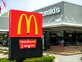 McDonalds logo, restaurant location and 24 hour drive through sign outside of remodeled location Royalty Free Stock Photo