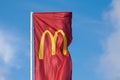 McDonalds red flag with logo of fast food restaurant branch, roadside flow in wind flag with logo