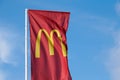 McDonalds red flag with logo of fast food restaurant branch, roadside flow in wind flag with logo